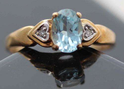 BLUE TOPAZ AND REAL DIAMOND RING. BEAUTIFUL HEART SHAPED SHOULDER FEATURE! YELLOW 9k GOLD