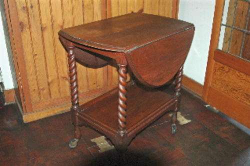 Barley twist tea trolley on castors, drop sides lift to make oval table. see desc. Collection