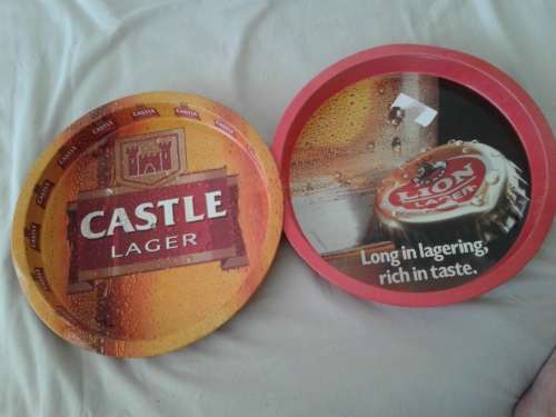 AUTHENTIC CASTLE -- AND LION LAGER BI-LINGUAL PUB SERVING TRAYS. GOOD CONDITION.