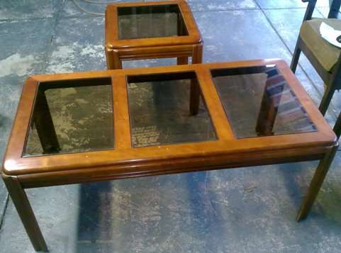 2 Wooden coffee tables with glass surfaces.