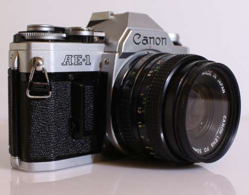 Vintage chrome AE-1 Canon SLR camera with 50mm lens, remote, flash,strap & bag