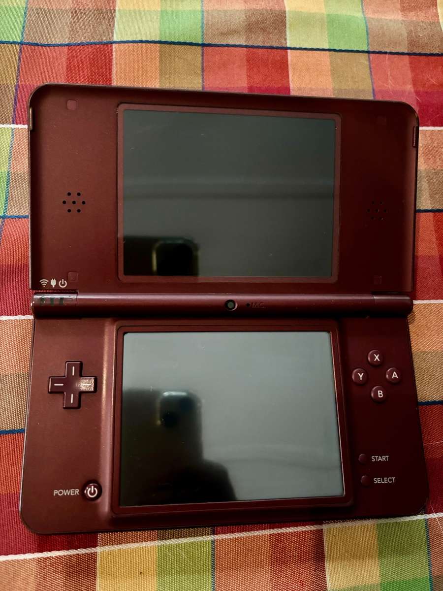 burgundy Nintendo DSi XL with charger