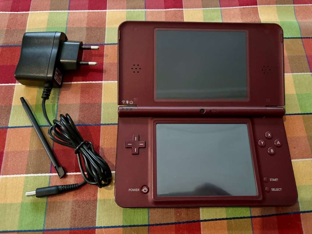 burgundy Nintendo DSi XL with charger