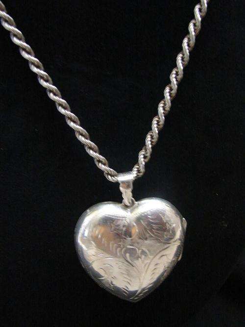 Silver locket - large heart shape .