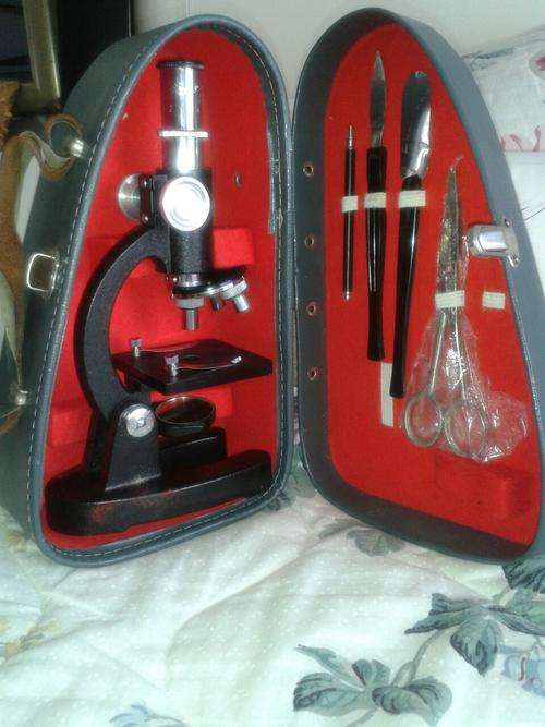 Small antique microscope in case