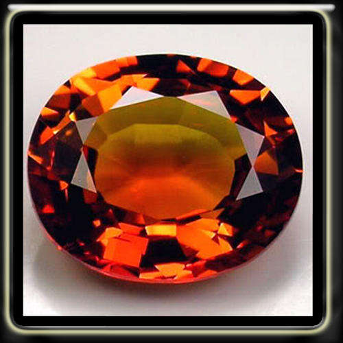 SIMMERING HOT 8.10CT GOLDEN SONGEA ORANGE SAPPHIRE, A POLISHED MODERN OVAL GEMSTONE