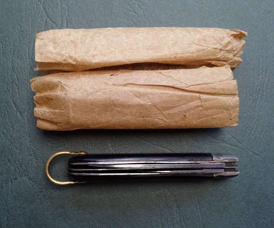 Vintage carbon steel pocket knife, unused in original brown paper wrapping.