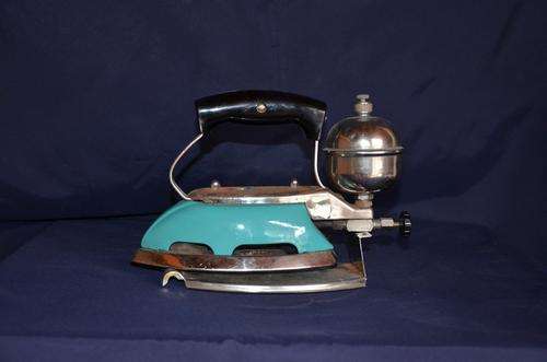 Antique Colemanm parrafin iron on stand