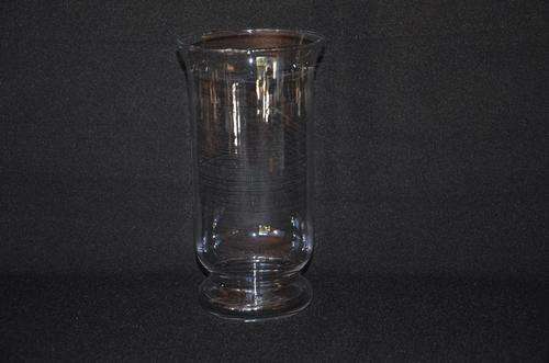 Glass vase, but originally used as a candle holder with sand surrounding the candle.