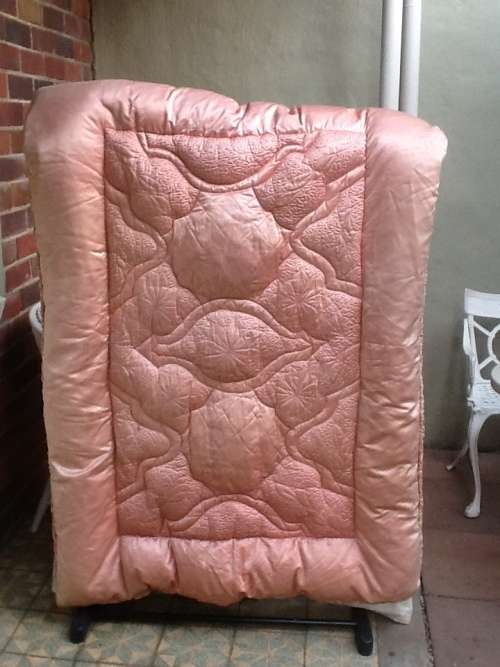 A Lovely Vintage Pink Feather Eiderdown for a Single Bed.