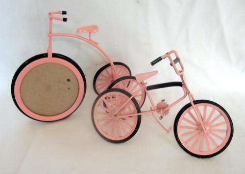 A PENNY FARTHING PHOTO FRAME AND ANOTHER BICYCLE ON A STAND