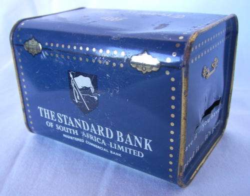 VERY OLD AND COLLECTABLE STANDARD BANK MONEY BOX, MADE OF TIN. NEVER BEEN OPENED