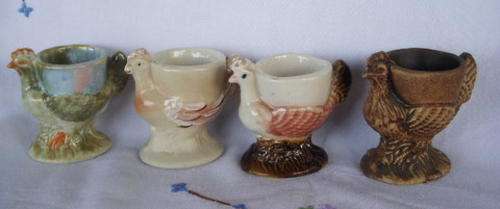 FOUR LOVELY EGGCUPS - SAME MOULD BUT DIFFERENT ARTISTS
