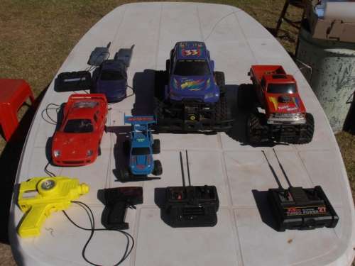 Lot radio controlled cars, Ferrari, monster trucks etc, played with condition, for parts, sold as is