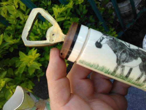 VINTAGE BRASS, BONE AND WOOD BOTTLE OPENER WITH SCRIMSHAW (?) ARTWORK