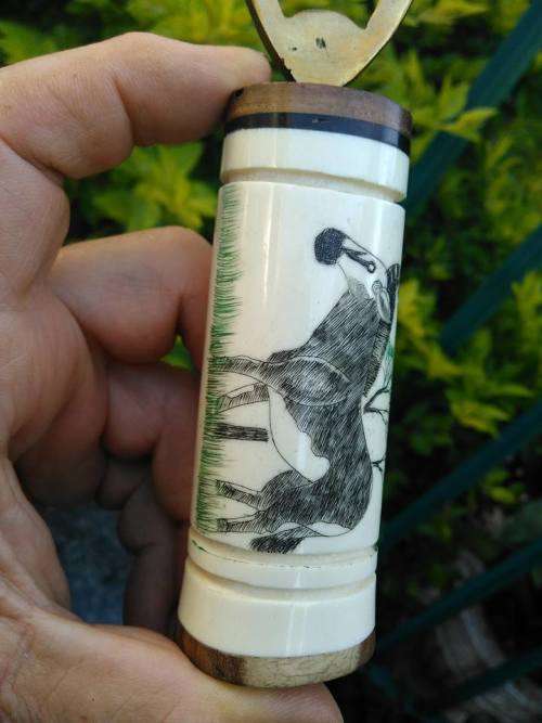VINTAGE BRASS, BONE AND WOOD BOTTLE OPENER WITH SCRIMSHAW (?) ARTWORK