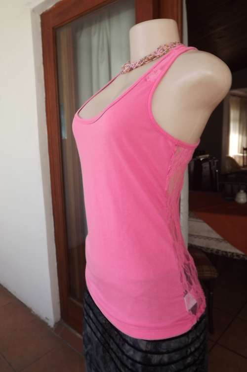 Pink Real Clothing tank top in 100% polyester.Laced back.Used but in good condition.
