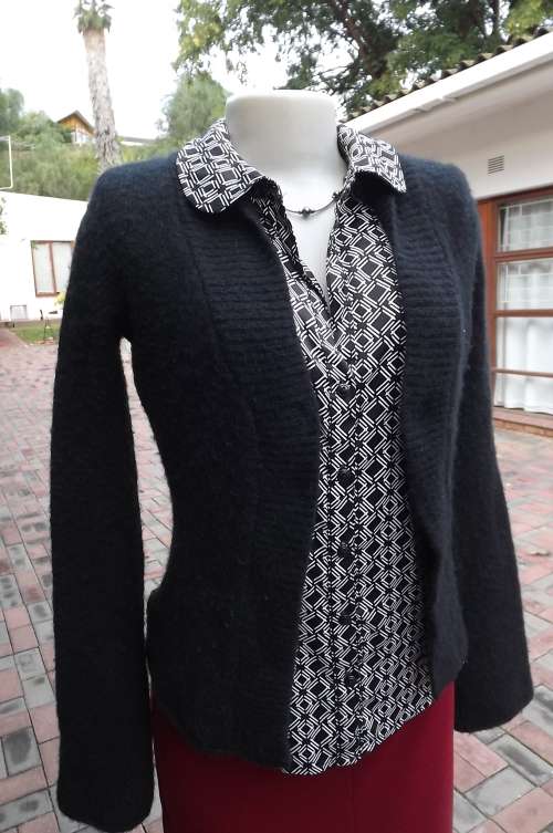 black open knit cardigan in 60% acrylic,30% cotton and 10% spandex.Size 32/8 by Truworths