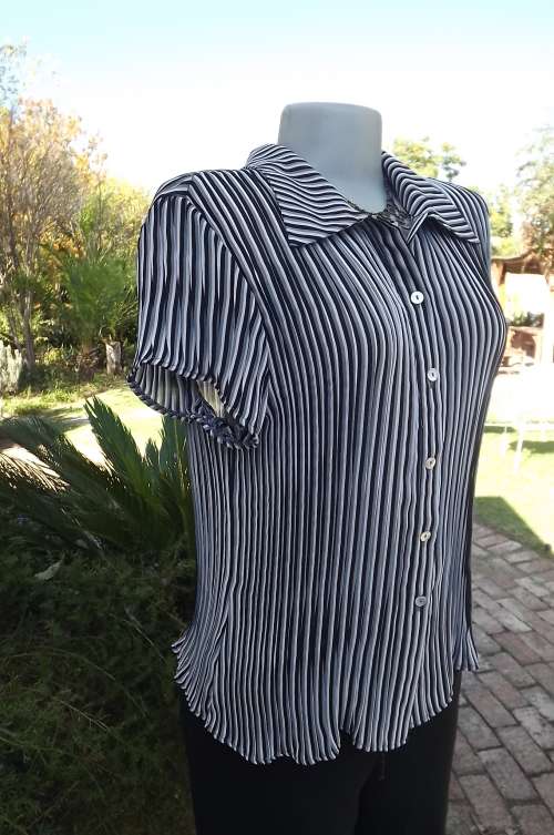 Black and white striped permanent pleated short capped sleeve top.By Kelso in size 34/10