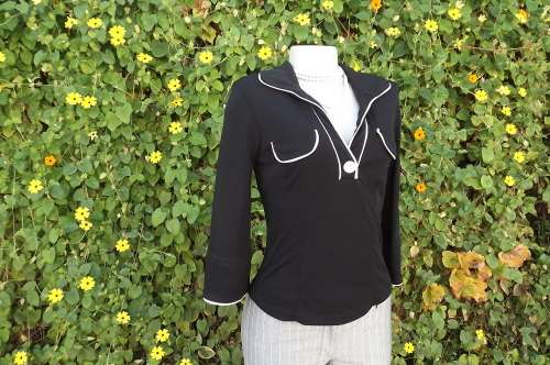 Sophisticated black top with white trim by Truworths size 32/8. 100% stretch polyester.