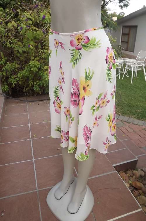 Sheer polyester half flare skirt in beige with colourful flowers.Size 38/14