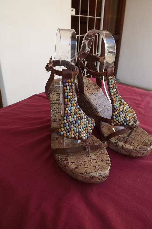 Pair of wedge sandals in size 5.High heel.Made from synthetic materials.Used but still fine
