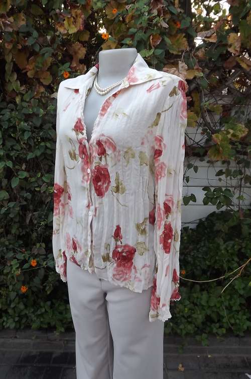 Beige permanent pleated long sleeve 100% polyester top.Size 34/10 by Truworths. Good condition
