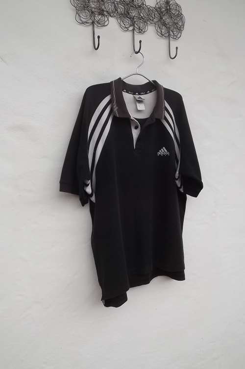 Black and white "Adidas" golf shirt in size L. Colour a bit faded with use.100% heavy cotton