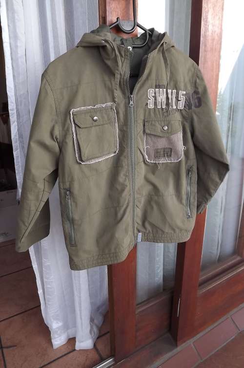 Army green hooded jacket for boy of 7 to 8 years old.Double zipped front.By Woolworths .As new