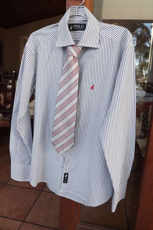 Top of the line shirt from "Polo" in blue and white stripes.Size M.Chest 106cm.New condition