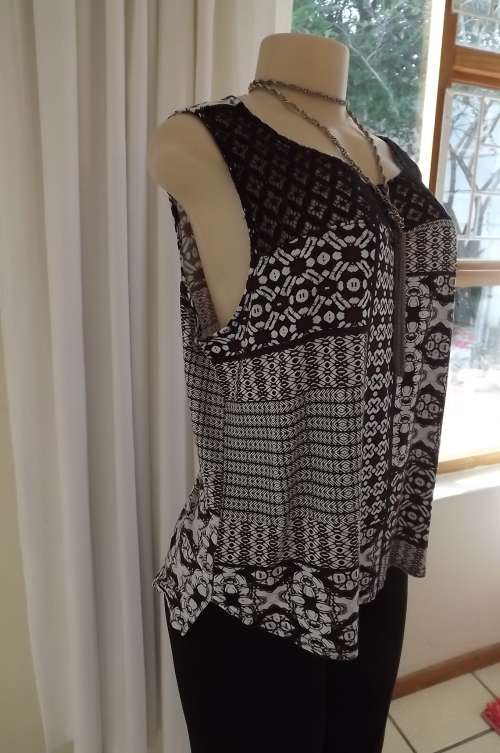 Cute geometric print loose cropped top with black lace shoulder front.Size 42/18 by Oakridge