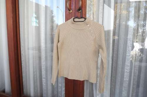 Beige boys knitted jumper in ribbed stitch for 9 to 10 year old.Left shoulder closing with 5 buttons