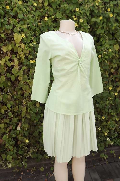 Soft mintgreen top with V neck and long sleeves.Size 34/10.Front embellished with tiny sequins