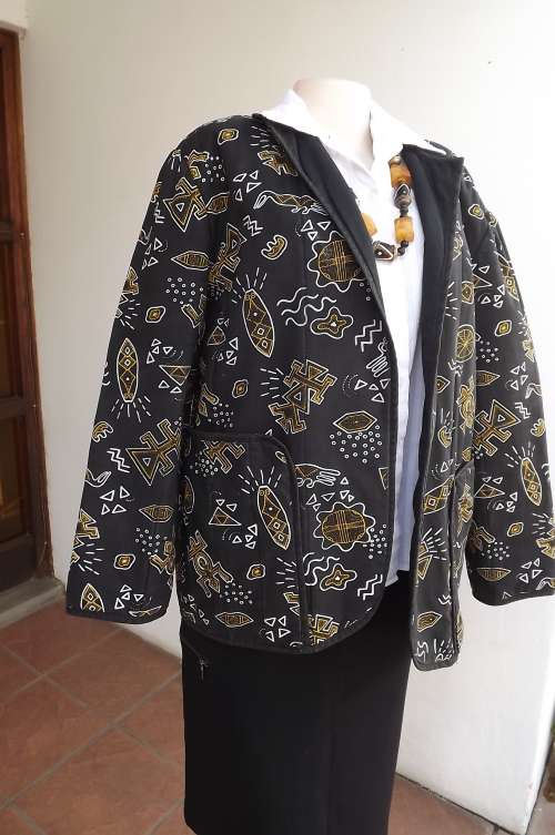 Padded black jacket with ethnic white/yellow patterns.Size 44/20.Two large pockets on front.