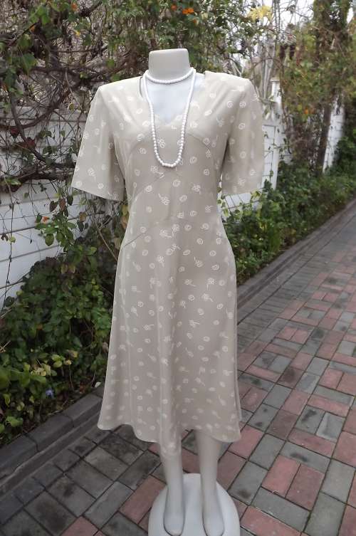 Ecru colour silky polyester short sleeves dress.Small white design.A-line style with V neck.