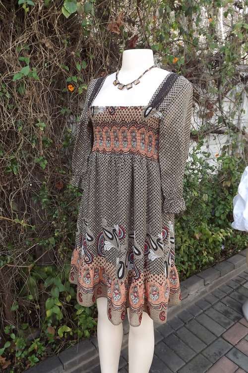 Fabulous dress in beige and browns with paisley border and frill.Size 34/10 by News.Elasticated top