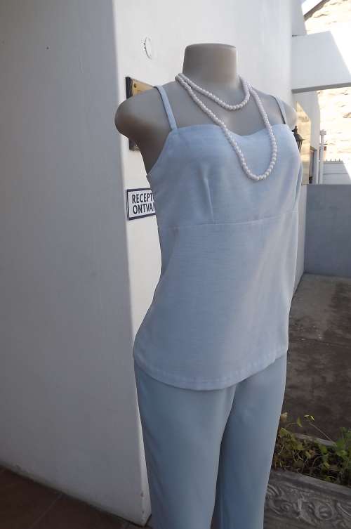Powder blue strappy top.Slip-over style.Size 34/10.Textured polyester fabric.No stretch.Good cond