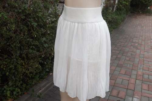 White permanent pleated knee length sheer polyester skirt with wide elasticated waistband.Size 32/8