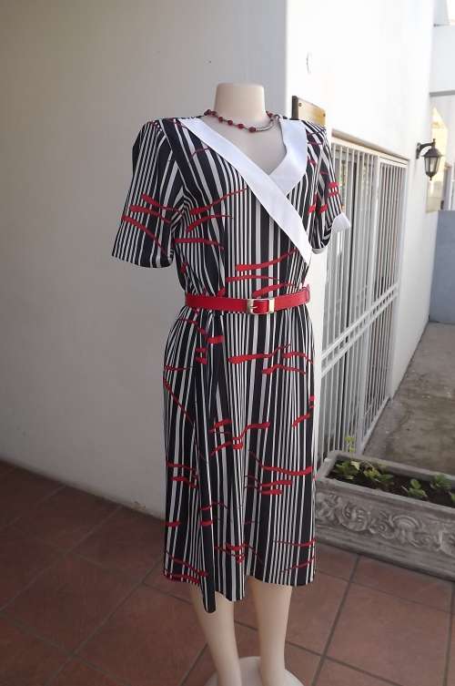 Beautiful vintage dress by Shelly size 40/16 in black and white strip with red accents.V neck.