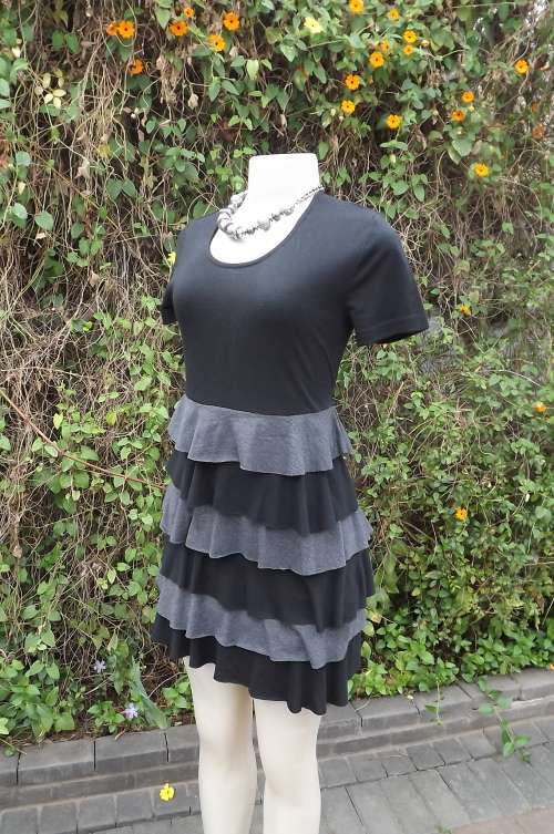 Trendy black stretch poly/viscose by Legit in size 32/8.Rounded neckline and short sleeves