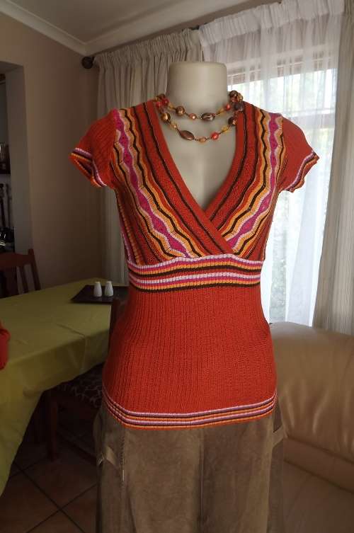 Brick colour ribbed V neck "Inwear" top in size 36/12.Pink/yellow stripes on top front.Acrylic knit