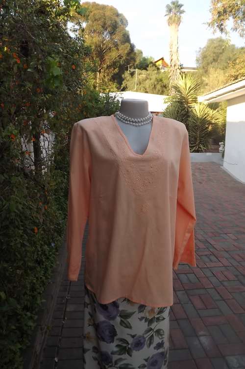 Pretty peach colour V neck loose top size 40/16. Delicate embroidery around neckline and cuffs
