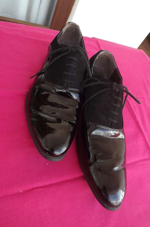 Pair of patent leather and Faux suede men's sharp pointed size 7 shoes.By "Renali"Only worn twice