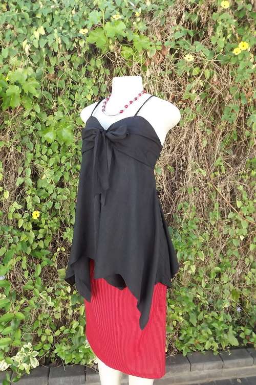 Black textured polyester strappy top with asymetrical seamline.Size 36/12.Elasticated at back.