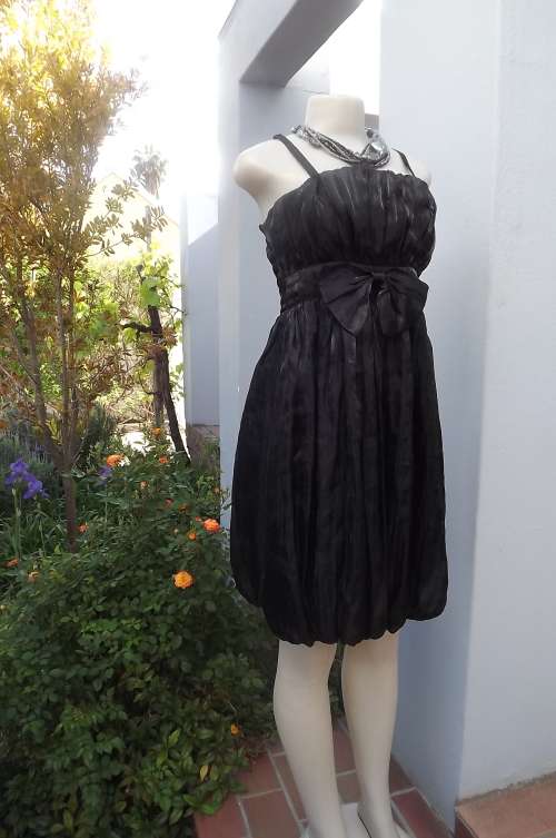 Sexy black knee length balloon cocktail dress in sheer glam polyester.Fully lined size 34/10 by EVA