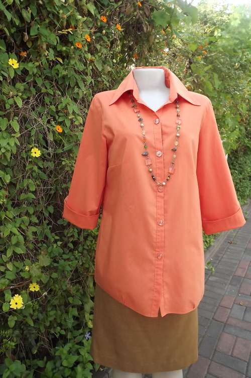 As new orange  colour top by OASIS size 40/16.Elbow length sleeves.In cool polycotton fabric.