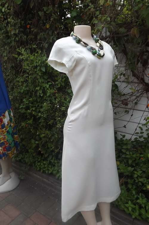 Pretty cream ankle length 100% polyester dress.Beautiful styled.Size 32/8.Short  cut-on sleeves