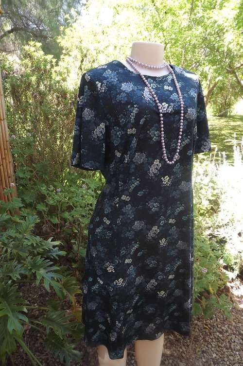 Very dark turquoise princess style dress in size 40/16 with posies of lighter turquoise