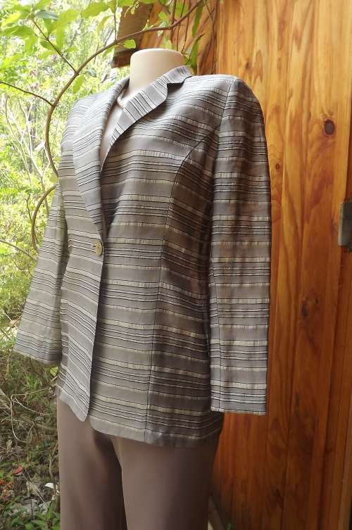 Amazing tailored PIERRE CARDIN jacket in a opuque fabric blend of raw silk,rayon and polyester.