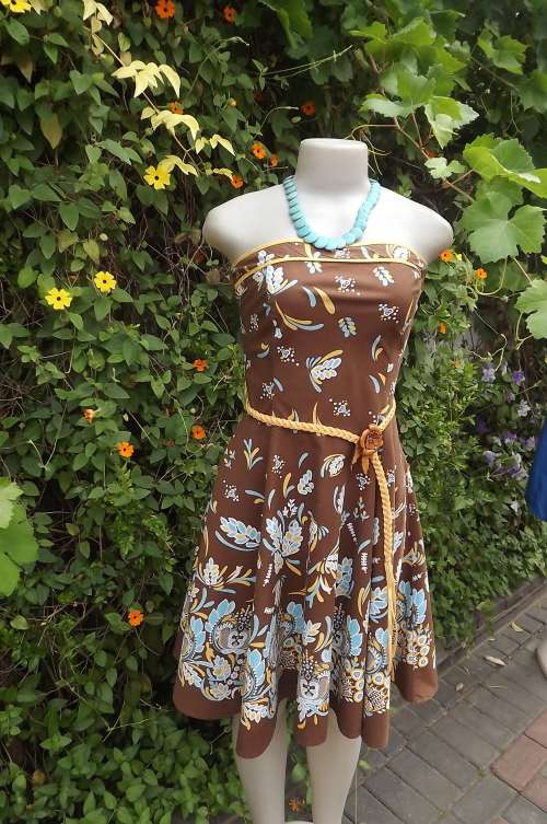 Sundress in brown with turquoise and yellow pattern and border.Size 32/8 by Legit.Flare skirt.